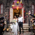 Breena and Brad's family celebrating their marriage in front of a church